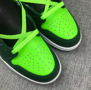Close-up of the fluorescent green perforated toe panels and contrasting dark green mudguards.