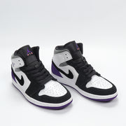 Three-quarter front view showing the black, white, and purple color blocking, padded collars, and high-top construction.