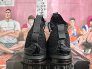 Rear view showing the black heel structure, pull tabs, strap details and outsole.