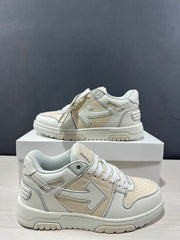Two cream-white sneakers shown from side and three-quarter angles, highlighting layered panels and arrow motifs.