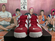 Front view of red and white Nike basketball sneakers showing the laces, toe panels, tongue logos, and white midsoles.
