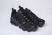 Pair of black Nike-style Air VaporMax Plus sneakers shown from the front side.