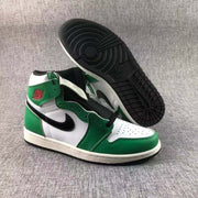 Sneakers displayed with one shoe lifted to show the black circular-pattern outsole.