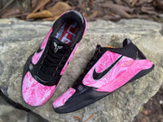 Angled view of both shoes showing patterned pink uppers