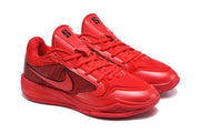 Three-quarter view of the red Nike basketball sneaker pair with lace-up fronts and padded collars.