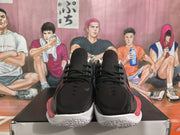 Front view of the pair showing black uppers, black laces, subtle swoosh details, and white textured outsoles.