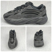 Composite view showing the side, top, and rear angles of the charcoal sneaker.