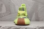 Rear view showing the padded heel, rear pull tab, and gum-colored outsole.