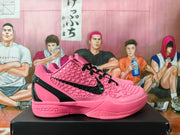 Side view of a pink Kobe basketball shoe with black laces, a black Swoosh, and textured star-patterned panels.