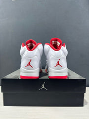 Rear view of the pair showing red heel logos, white uppers and red outsole sections.