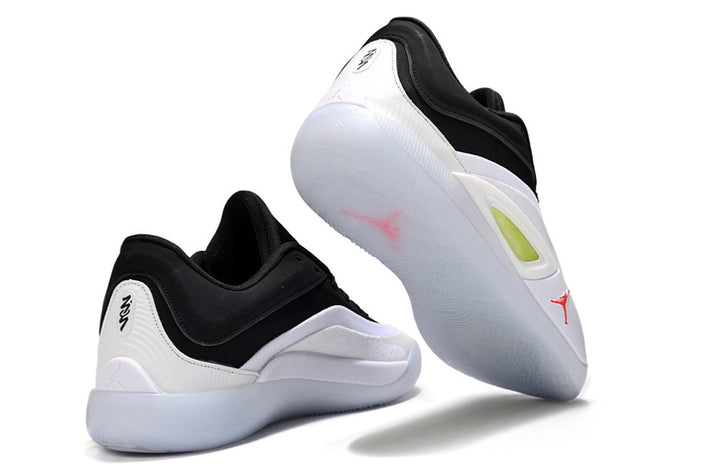 White and black Jordan Zion 4 sneakers shown from rear and outsole angles.
