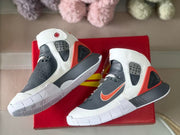 Angled top view showing both shoes, their red-and-gray color blocking, and outsole edges.