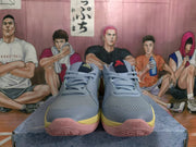 Front view showing the paired blue and gray basketball sneakers with mesh toe panels, laces, and contrasting yellow and pink sole accents.