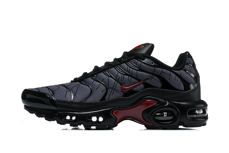 Side view of black, grey and deep red Nike Air Max Plus sneakers.
