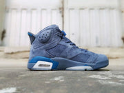 Side profile of the blue high-top sneaker with perforated panels and layered outsole.