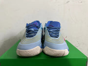 Front view of blue Nike high-top sneakers with curved yellow detailing and light-colored outsoles