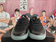 Front view of the pair showing black perforated toe panels, laces, tongues, and mint green outsole accents.