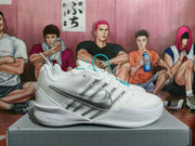 Side view showing the silver Swoosh and textured panels on a white Nike shoe