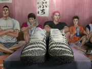 Front view of the pair showing white laces, patterned gray-and-white toe boxes, and dark geometric outsoles.