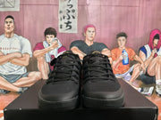 Front view of the black basketball sneakers showing the laces, textured uppers, and layered black outsoles.