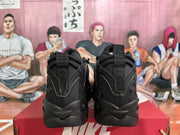 Rear view of black Nike sneakers with pull tabs and sculpted soles.