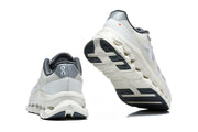 Heel and outsole views of white and grey On Cloudtilt Remix sneakers
