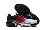 Nike Air Max Plus sneaker side view with the outsole visible, showing a white, red, and black design.
