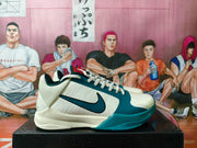 Side profile of one blue and white Nike basketball sneaker showing the layered upper, Swoosh, and blue outsole.