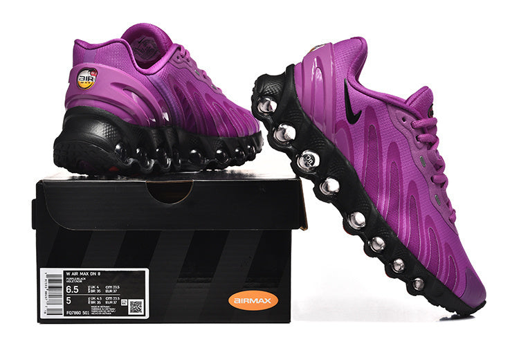 Purple Nike Air Max DN 8 sneakers shown from the side and rear on a shoebox; the box label shows a sample size.