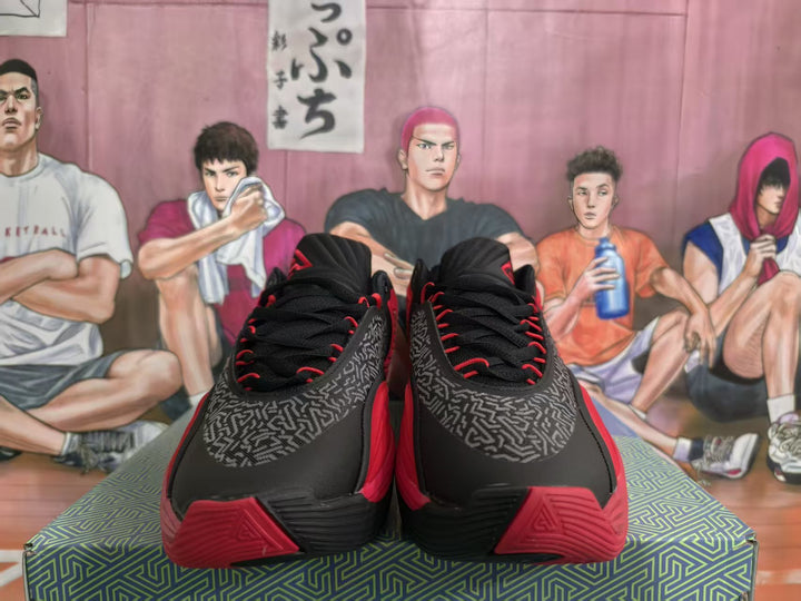 Pair of black and red Nike basketball sneakers shown from the front, with patterned side panels and red accents.