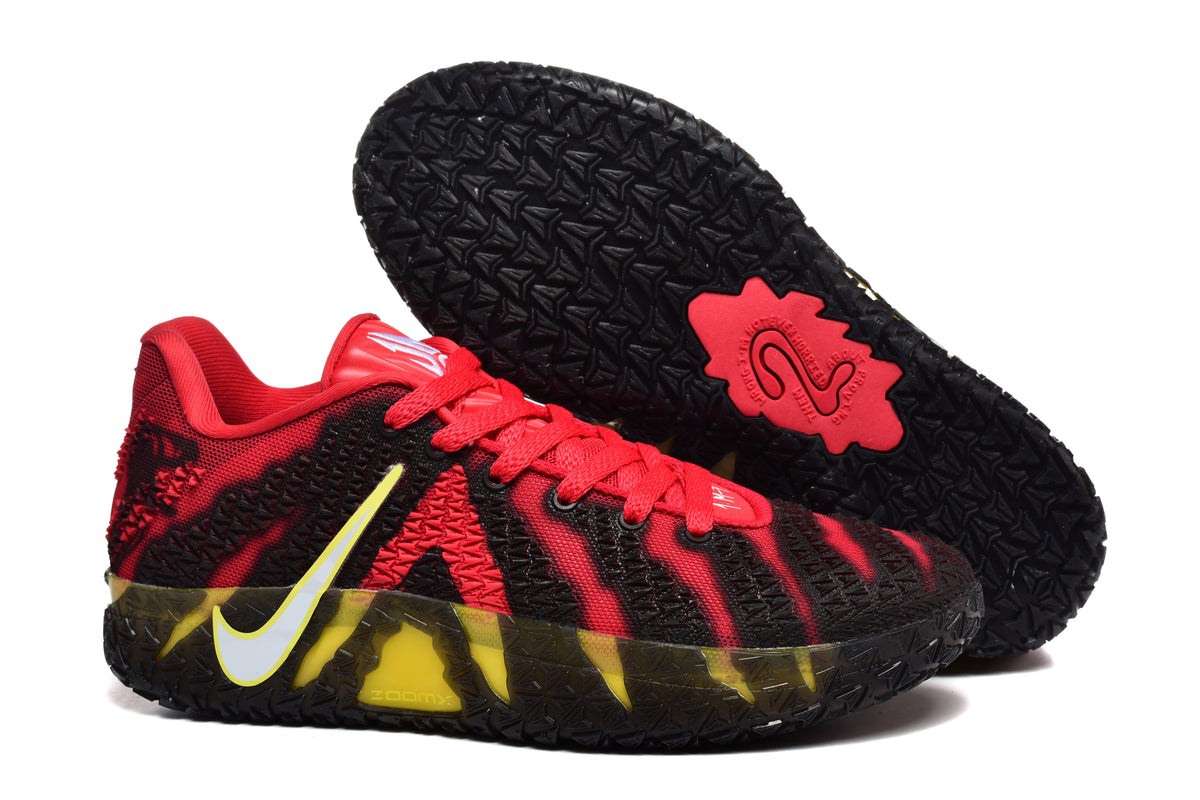Red and black Nike basketball sneakers with yellow accents, textured uppers, and black patterned outsoles.