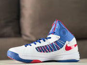 Close side view showing the blue upper, white overlays, red accent, and high-top shape.