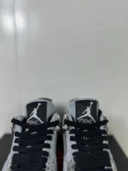 Close view of the tongue labels, black laces, and silver-tone lace hardware.