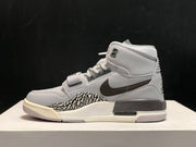 Outer side profile showing the brown Swoosh, elephant-print panel and visible sole window detail.