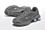 Pair of dark grey Nike Shox Ride 2 sneakers shown from the side