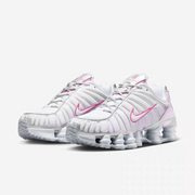 Pair of white and pink Nike Shox TL-style sneakers shown from the front at an angle.