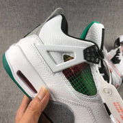 Close-up of the side showing the white support wing, multicolor mesh panel, grey speckled midsole, and green outsole.