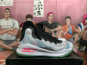 Side view of a high-top basketball shoe with a multicolor patterned upper, white midsole, and green outsole.
