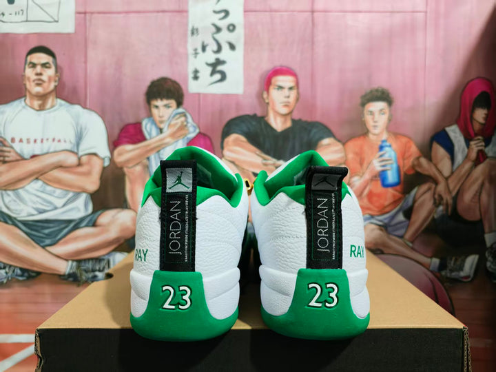 Rear view of white and green Jordan sneakers showing black Jordan heel tabs, green heel panels, and the number 23.