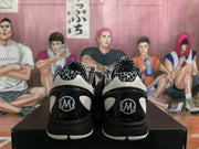 Rear view of the pair showing patterned collar lining, black heel panels, and GIGI and KOBE graphics.