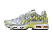 Side view of grey and volt yellow-green Nike Air Max Plus VII sneakers.