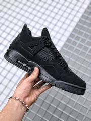 Side profile of the black high-top sneaker with lace-up front and patterned outsole.