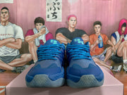 Front view of blue Puma sneakers showing the laces, tongues, toe panels and patterned outsole edges.
