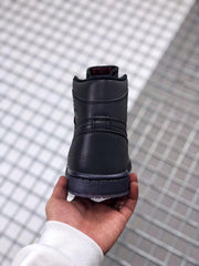 Rear view of the black high-top sneaker showing the padded collar and translucent outsole edge.