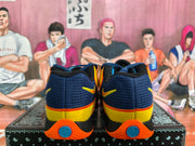 Rear view of navy Nike basketball sneakers with yellow heel panels and orange outsoles