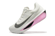Angled side view of a white Nike Zoom Fly 6 shoe with a pink-and-black sculpted sole.