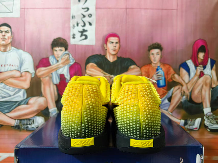 Rear view of yellow and black Nike basketball shoes showing textured heels and yellow heel tabs
