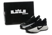 Pair of black and white shoes beside a black box marked with LeBron and TRAINING graphics.