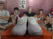 Front view showing the paired white and pale purple Nike sneakers with lace-up closures and perforated toe panels.