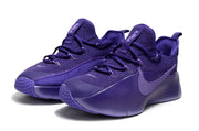 Pair of tonal purple sneakers in a front three-quarter view.
